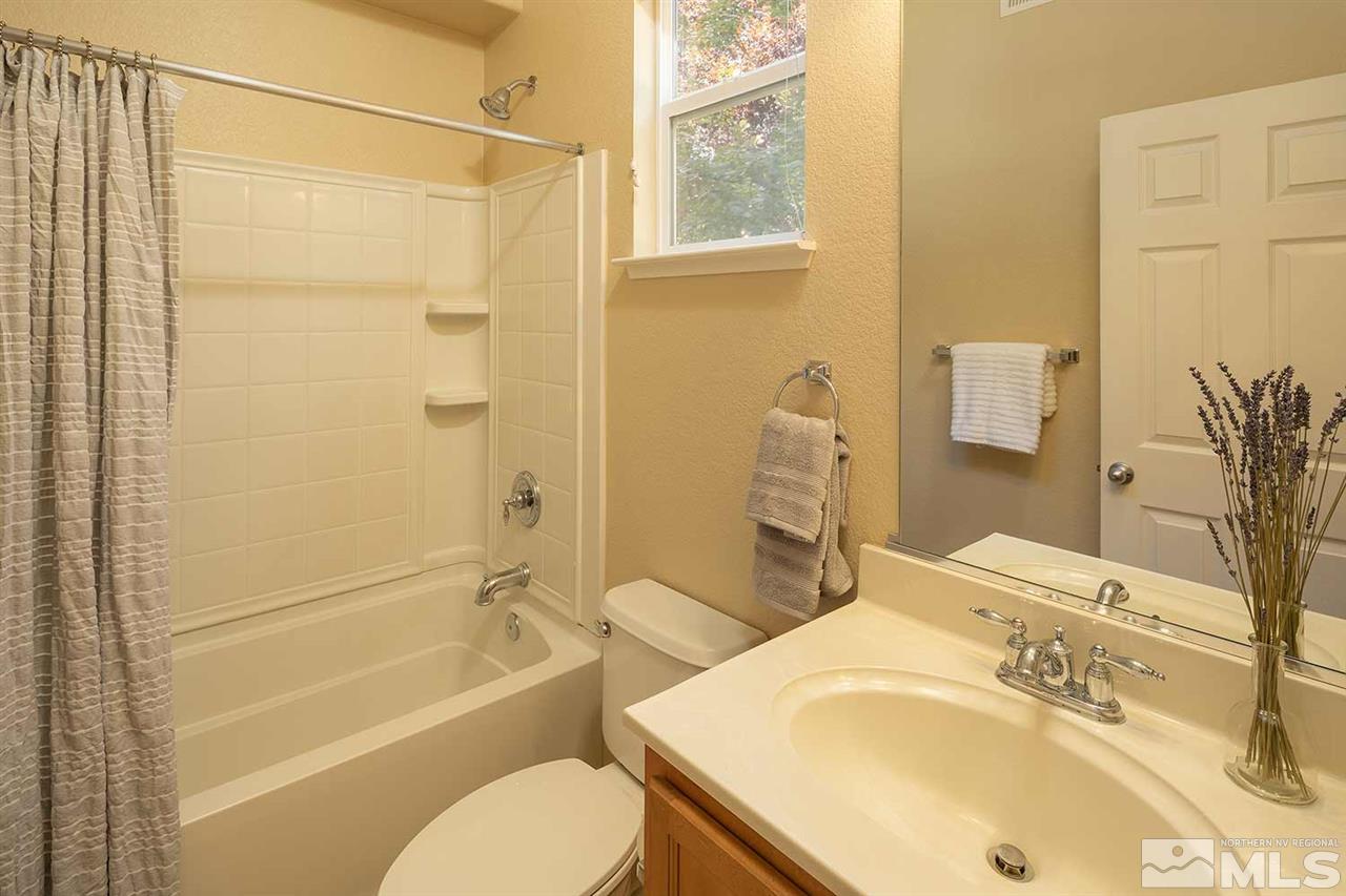4599 Keyhaven Drive Reno, NV 89502 - Photo 11 of 28 a bathroom with a sink toilet and shower