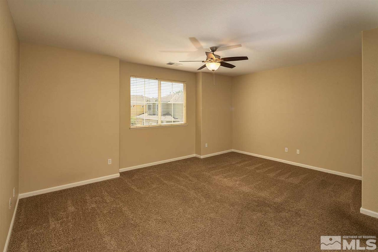 4599 Keyhaven Drive Reno, NV 89502 - Photo 16 of 28 an empty room with windows and fan