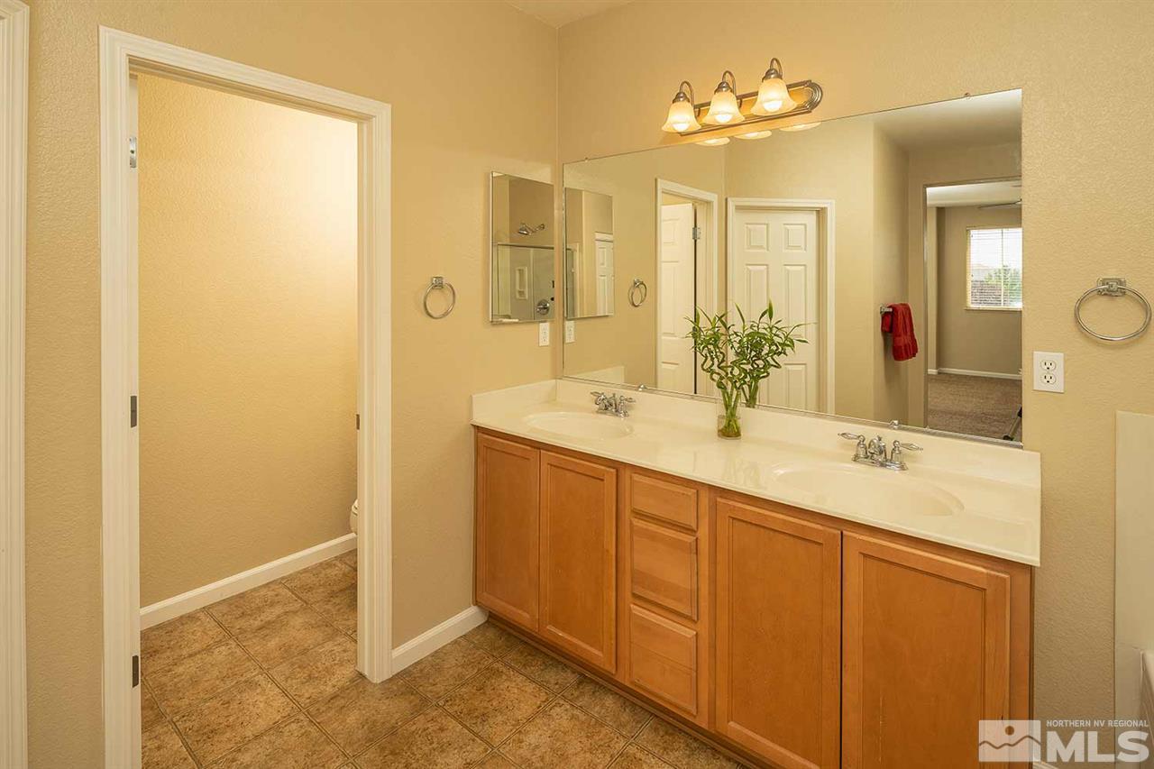 4599 Keyhaven Drive Reno, NV 89502 - Photo 18 of 28 a bathroom with a double vanity sink mirror and shower