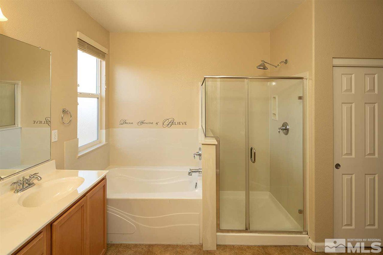 4599 Keyhaven Drive Reno, NV 89502 - Photo 19 of 28 a bathroom with a shower sink and mirror