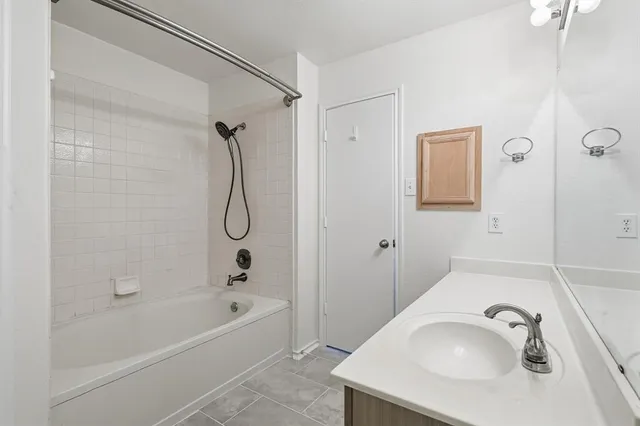 a bathroom with a sink vanity tub and a shower