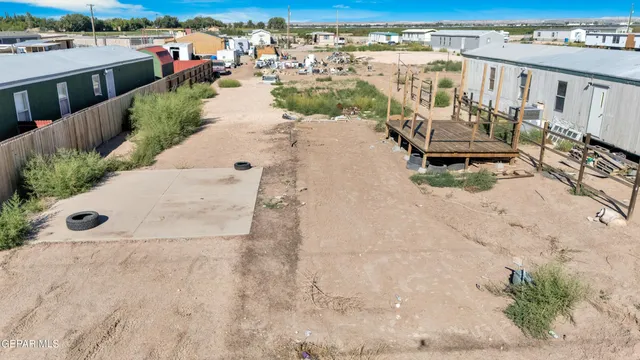 a view of a terrace with a garden and lawn chairs
