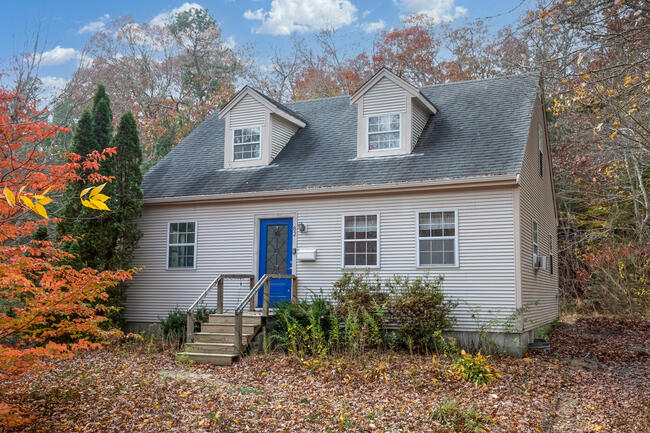 82 Deerfield Road Mashpee, MA 02649 - Photo 1 of 16 a house that has a tree in front of it