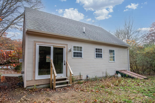 82 Deerfield Road Mashpee, MA 02649 - Photo 3 of 16 a view of a house with a yard
