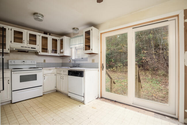 82 Deerfield Road Mashpee, MA 02649 - Photo 4 of 16 a kitchen with a stove top oven sink and cabinets