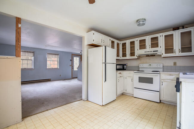 82 Deerfield Road Mashpee, MA 02649 - Photo 5 of 16 a kitchen with stainless steel appliances a refrigerator sink and cabinets