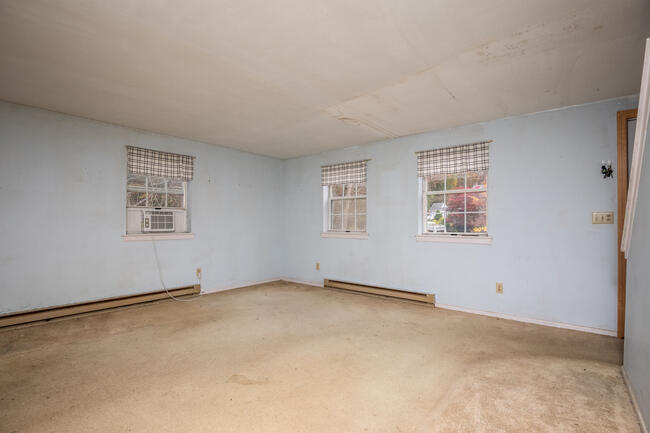 82 Deerfield Road Mashpee, MA 02649 - Photo 8 of 16 an empty room with windows