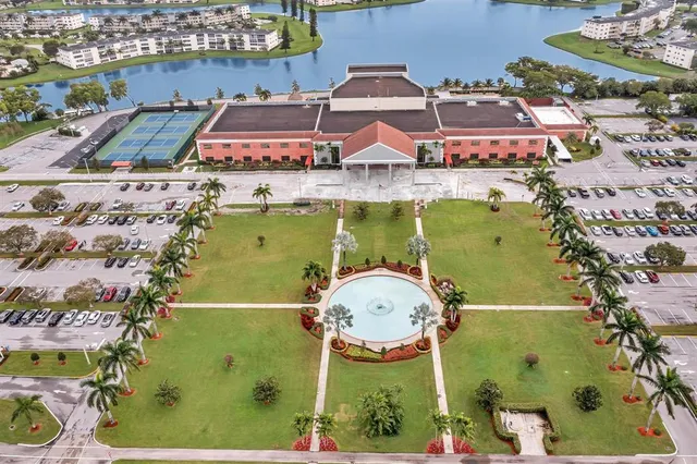 an aerial view of a residential houses with outdoor space and seating area