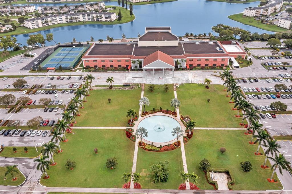 an aerial view of a residential houses with outdoor space and seating area