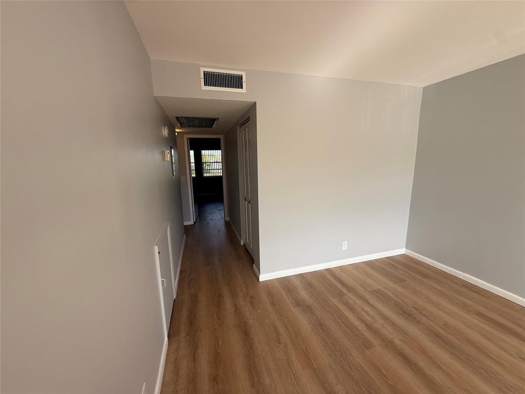2017 Newcastle A, Unit 2017 Boca Raton, FL 33434 - Photo 15 of 41 a view of a hallway with wooden floor