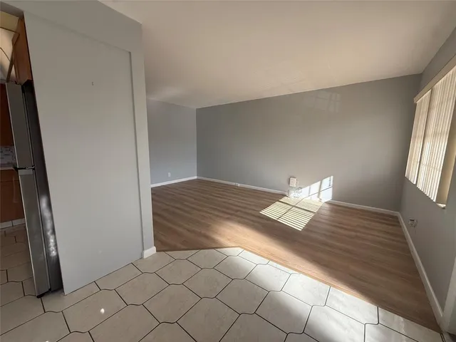 a kitchen with stainless steel appliances a sink and a refrigerator