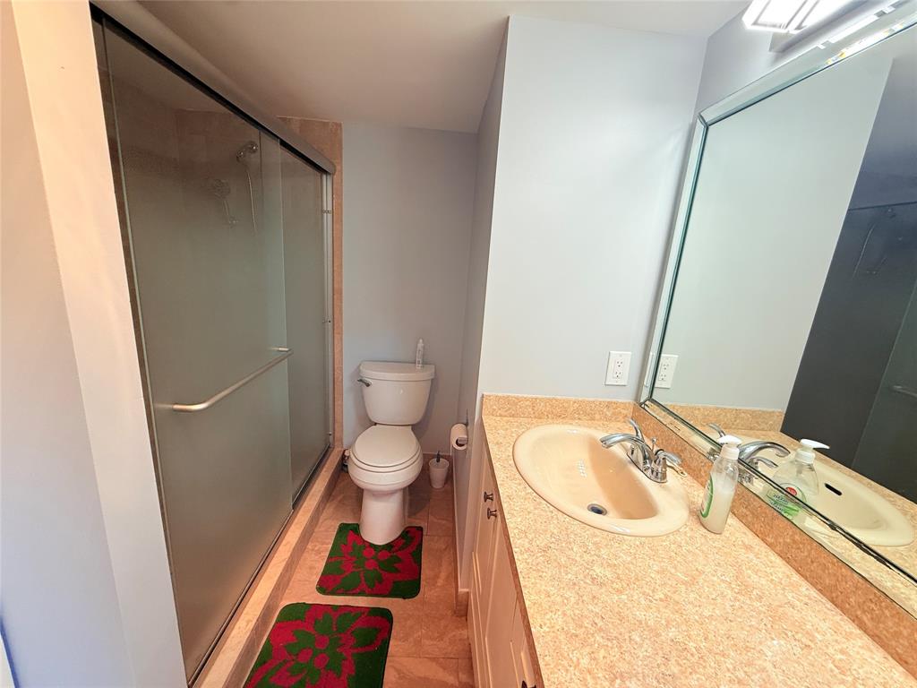 2017 Newcastle A, Unit 2017 Boca Raton, FL 33434 - Photo 24 of 41 a bathroom with a sink and a mirror