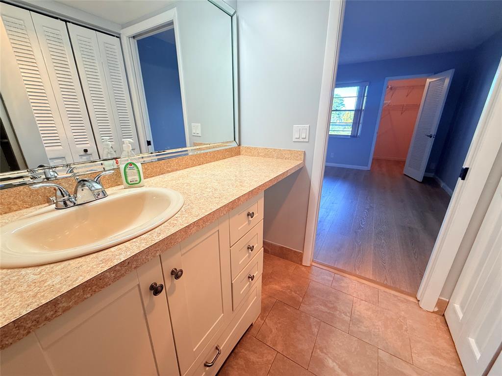 2017 Newcastle A, Unit 2017 Boca Raton, FL 33434 - Photo 26 of 41 a bathroom with a sink and a mirror