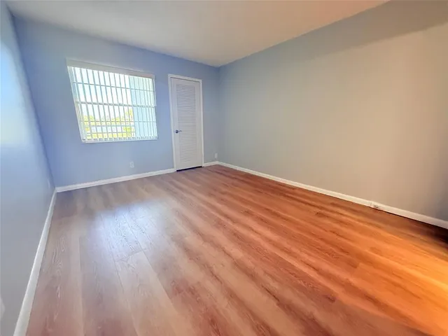 a spacious bathroom with a toilet sink and a mirror