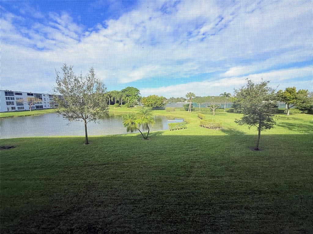 2017 Newcastle A, Unit 2017 Boca Raton, FL 33434 - Photo 32 of 41 a view of a lake with a big yard