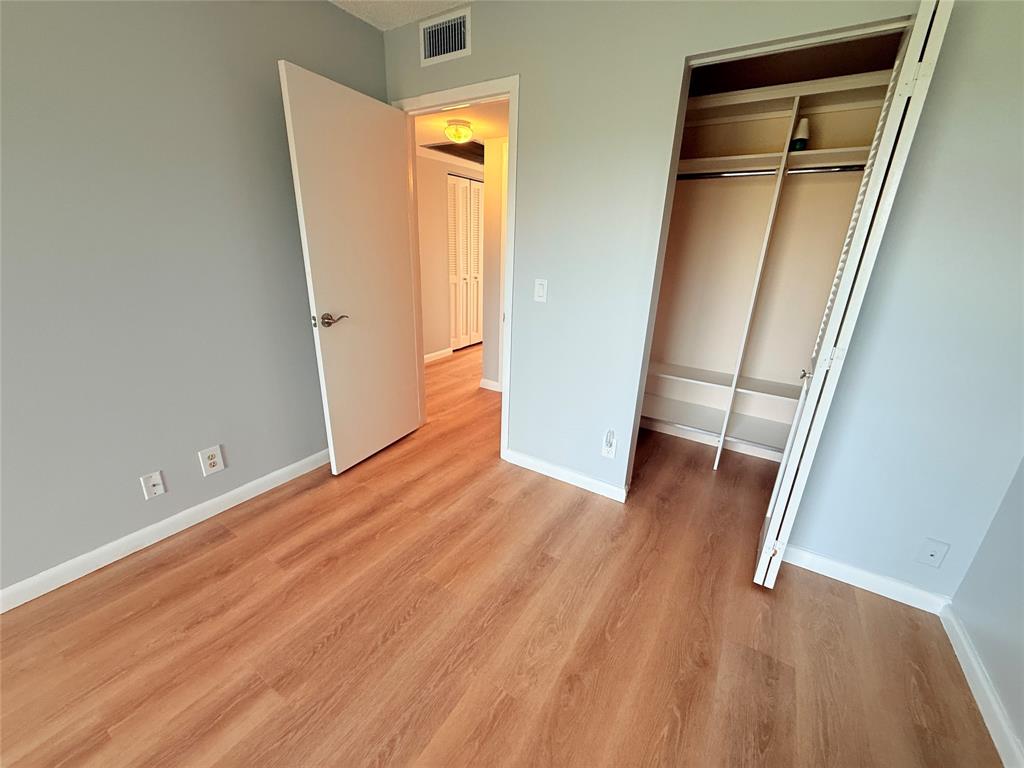 2017 Newcastle A, Unit 2017 Boca Raton, FL 33434 - Photo 34 of 41 an empty room with wooden floor and entrance