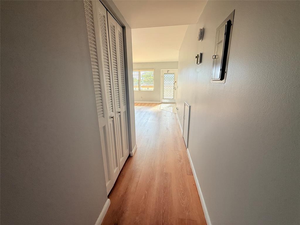 2017 Newcastle A, Unit 2017 Boca Raton, FL 33434 - Photo 36 of 41 a view of a hallway with wooden floor and staircase