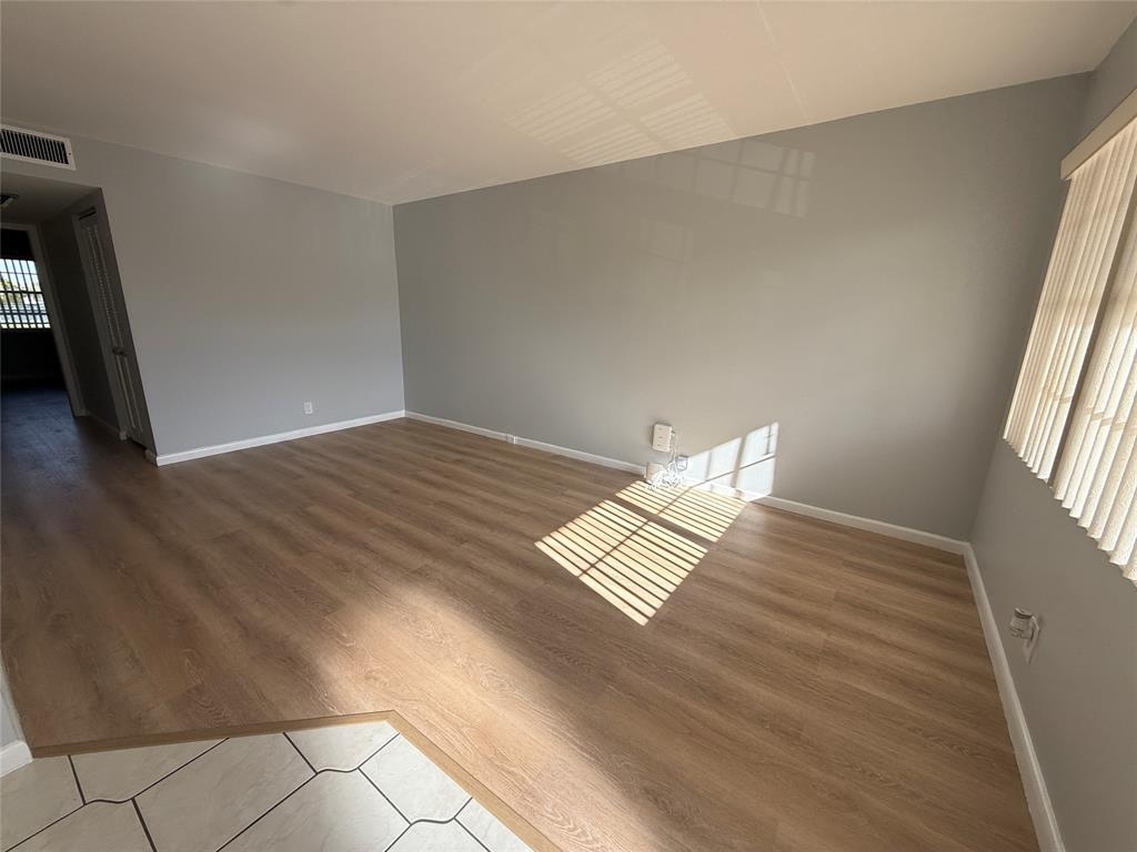 2017 Newcastle A, Unit 2017 Boca Raton, FL 33434 - Photo 9 of 41 wooden floor in an empty room with a window