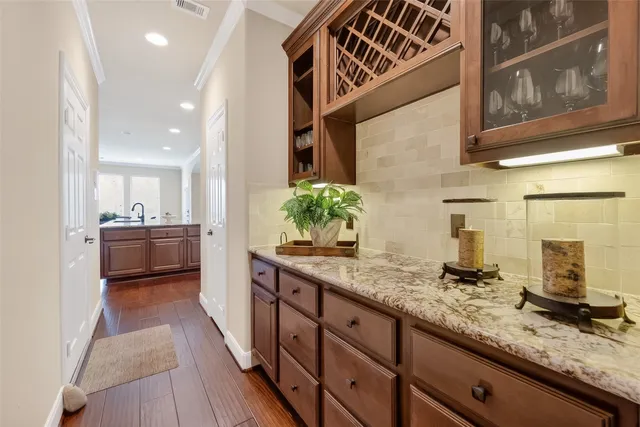 a kitchen with stainless steel appliances granite countertop a sink a stove and cabinets