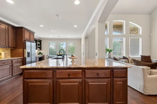 a view of a kitchen counter top space with patio furniture and a granite counter top