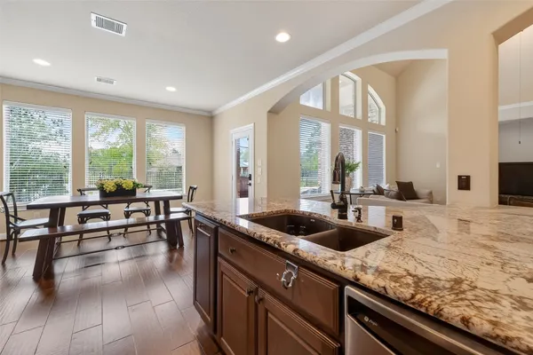 a kitchen with stainless steel appliances granite countertop a sink refrigerator and cabinets