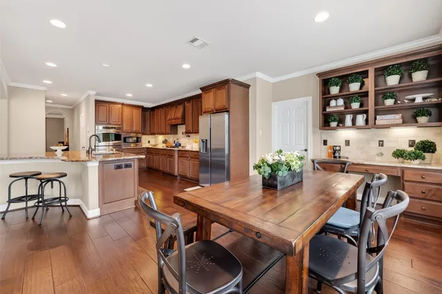 a view of a dining room with furniture and wooden floor