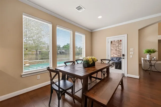 a dining room with furniture and wooden floor