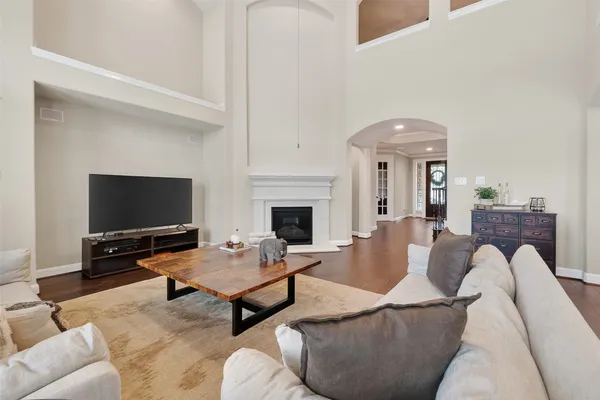 a living room with furniture wooden floor and a large window