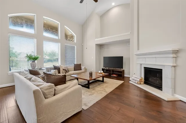 a living room with furniture wooden floor and a fireplace
