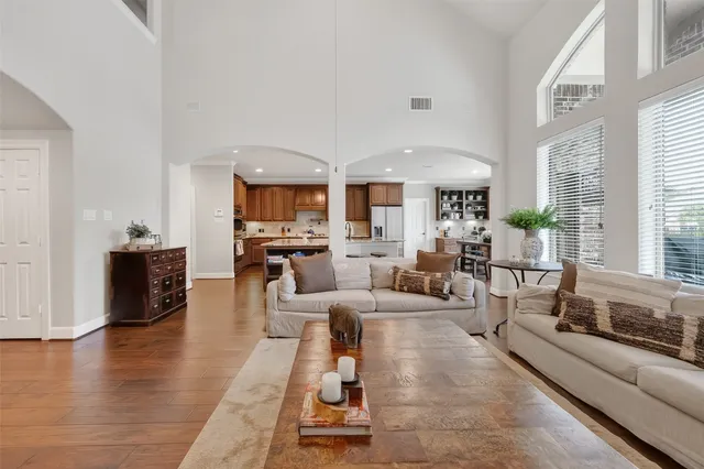 a living room with furniture wooden floor and a large window