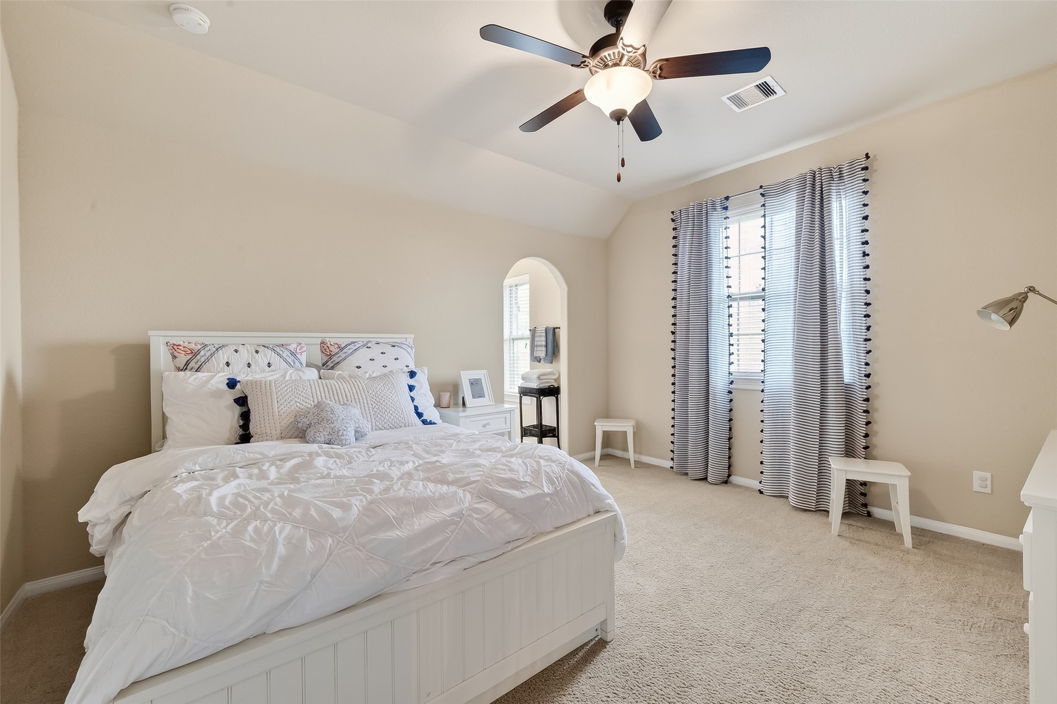 10 Cayuga Pond Court Spring, TX 77389 - Photo 31 of 50 a spacious bedroom with a bed and a chandelier