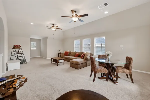 a living room with furniture a rug and a chandelier