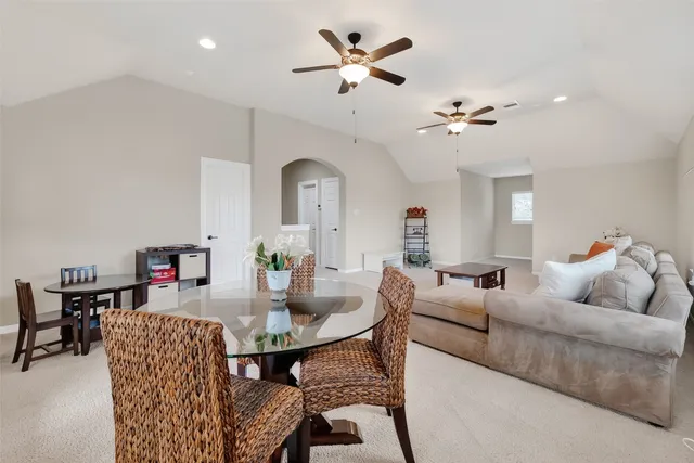 a living room with furniture a rug and a chandelier