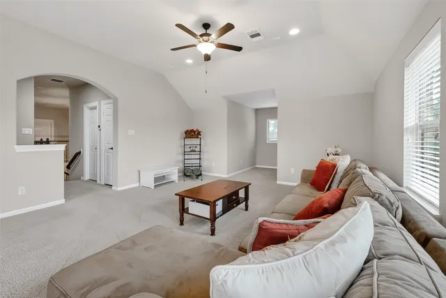 a living room with furniture and a large window