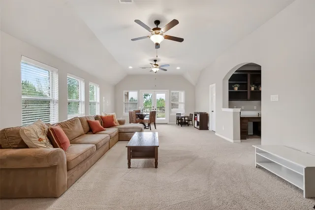 a living room with furniture a fireplace and a chandelier