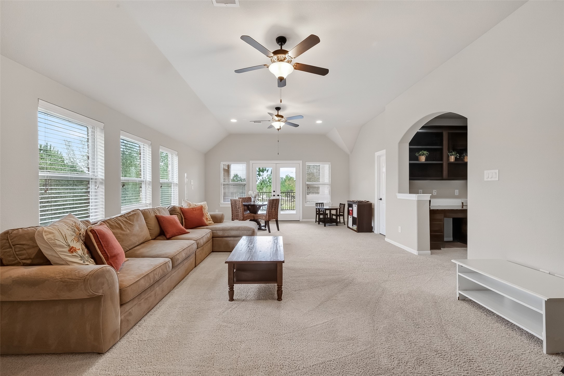 10 Cayuga Pond Court Spring, TX 77389 - Photo 42 of 50 a living room with furniture a fireplace and a chandelier