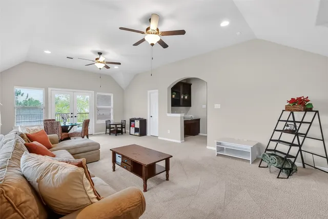 a living room with furniture a rug and a chandelier