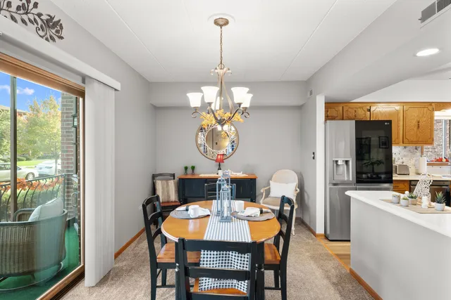 a dining room with furniture a mirror and a large window