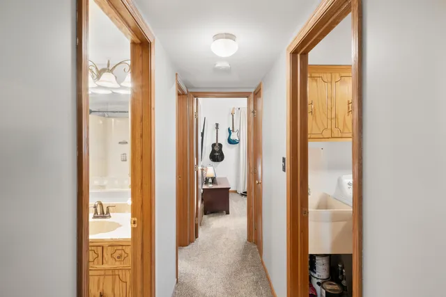 a view of a hallway with wooden floor and windows