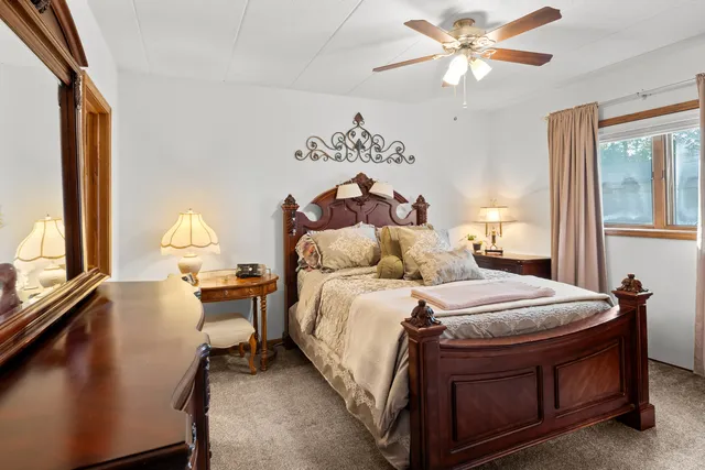 a bed room with a bed and a chandelier
