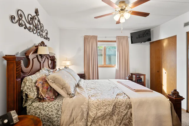 a bedroom with a bed and a chandelier