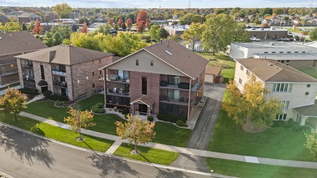 an aerial view of a house with a garden and yard