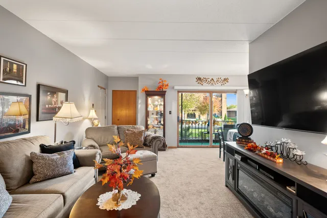 a living room with furniture fireplace and flat screen tv