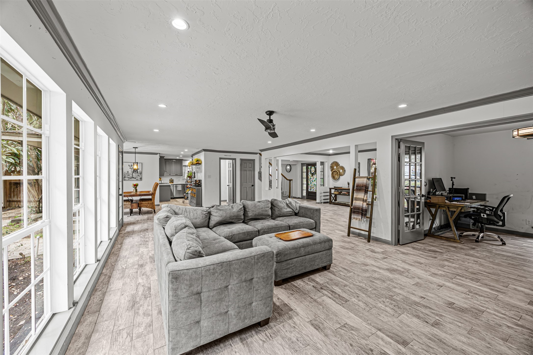 6511 Elmgrove Road Spring, TX 77389 - Photo 11 of 33 This open-concept living space features large windows, allowing natural light to flood in. Adjacent to the living area is a home office, perfect for modern family living.