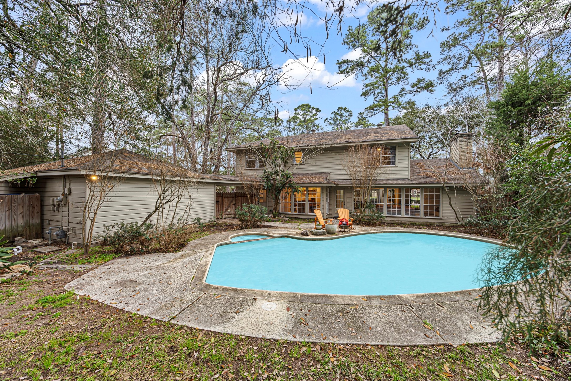 6511 Elmgrove Road Spring, TX 77389 - Photo 2 of 33 Step into your private retreat with mature trees, lush landscaping, and a resort-style pool—perfect for relaxing or entertaining.