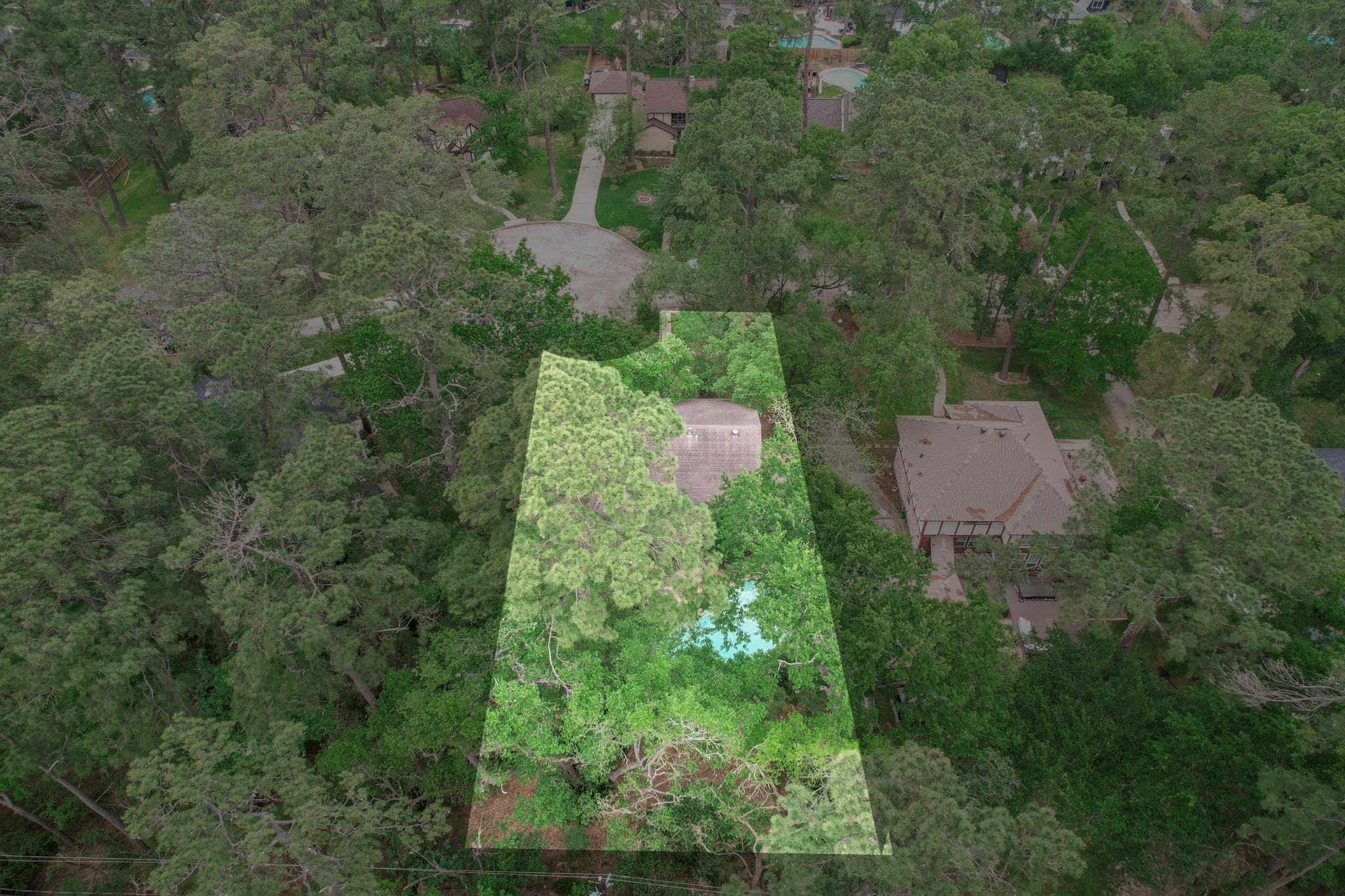 6511 Elmgrove Road Spring, TX 77389 - Photo 29 of 33 This aerial view highlights a private backyard retreat with a resort-style, in-ground pool, enveloped by lush greenery and mature trees—creating a tranquil and secluded setting.