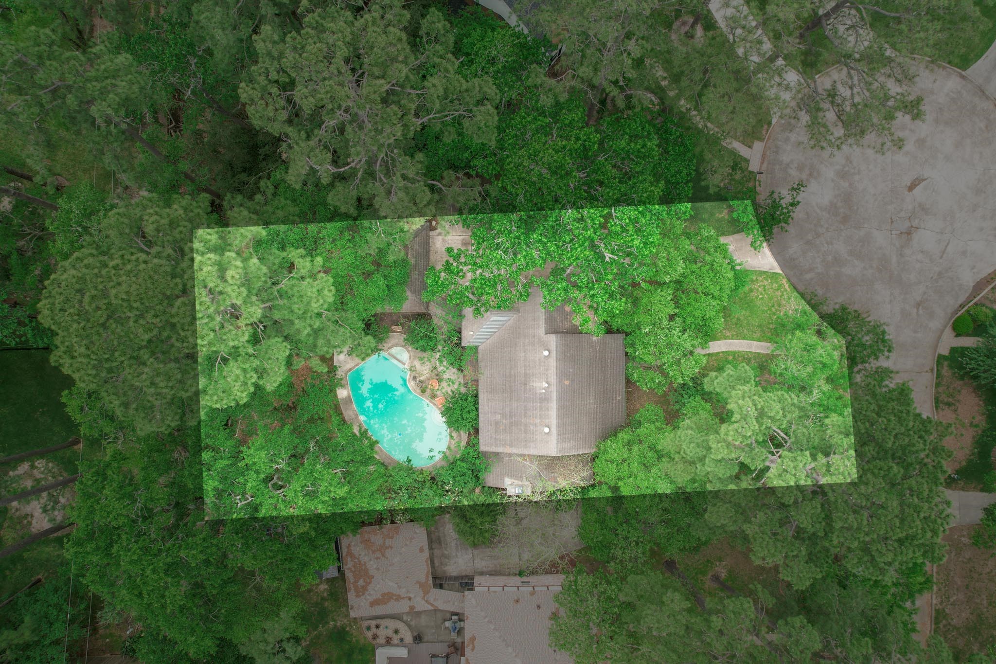 6511 Elmgrove Road Spring, TX 77389 - Photo 8 of 33 Tucked among mature trees and vibrant greenery, the freeform pool blends seamlessly with its natural surroundings, creating a peaceful, woodland-like retreat perfect for unwinding in harmony with nature.