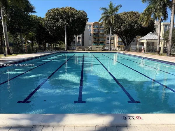 a view of a room with gym equipment and floor to ceiling windows