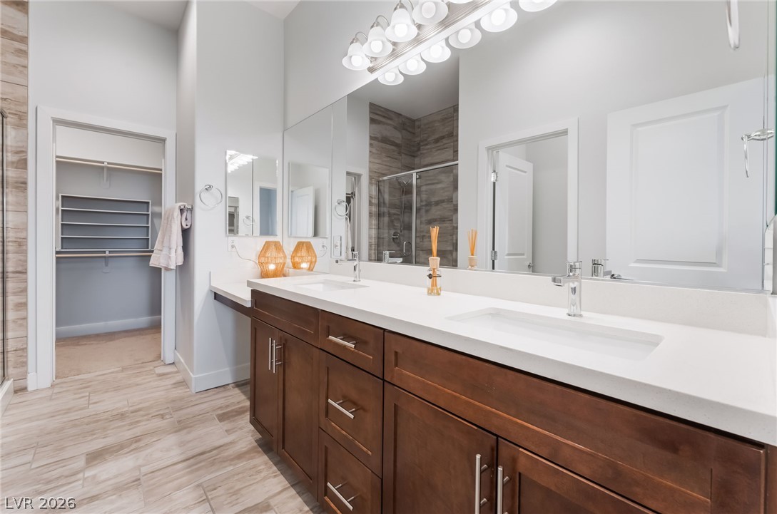 6432 Spring Jog Street Las Vegas, NV 89166 - Photo 21 of 61 Double vanities and modern fixtures define this pristine bathroom, with an adjacent walk-in closet for convenience.