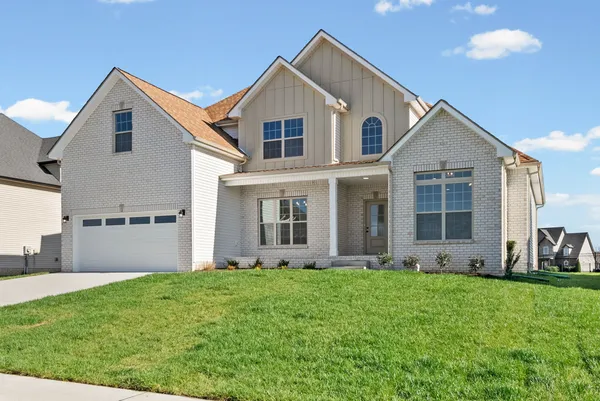 a kitchen with stainless steel appliances granite countertop a sink dishwasher a refrigerator and a oven with wooden floor